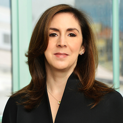 Head shot of a woman with long brown hair wearing a black shirt